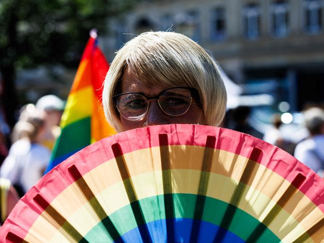 A participant holds a fan in rainbow colors during the yearly Christopher Street Day (CSD) LGBTQ pride event in Pirna, eastern Germany on July 13, 2024. The 13th Christopher Street Day is themed 'Diversity connects'. (Photo by JENS SCHLUETER / AFP)