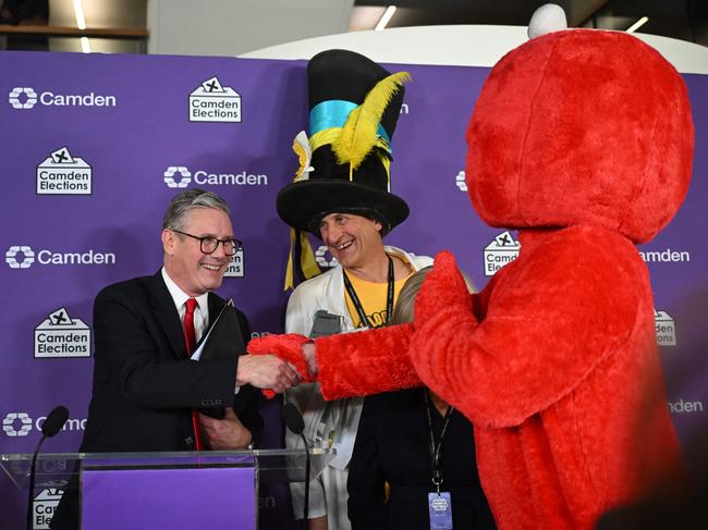 Britain's Labour Party leader Keir Starmer is congratulated by fellow candidates Bobby 'Elmo' Smith (R) and Nick 'The Flying Brick' Delves (2ndR) after winning his seat for Holborn and St Pancras at the Camden Council count centre in London early on July 5, 2024 after polls closed in Britain's general election. Britain's main opposition Labour party looks set for a landslide election win, exit polls indicated, with Keir Starmer replacing Rishi Sunak as prime minister, ending 14 years of Conservative rule. (Photo by JUSTIN TALLIS / AFP)