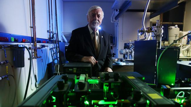 Clean and green: Physicist Heinrich Hora inhales the helium at the UNSW School of Physics. Picture: Britta Campion.