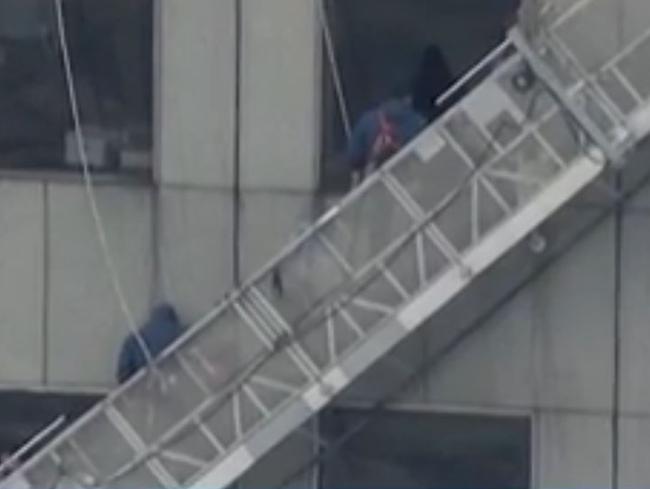 Rescue mission ... firefighters managed to pull the window washers to safety. Picture: KHOU 11 News