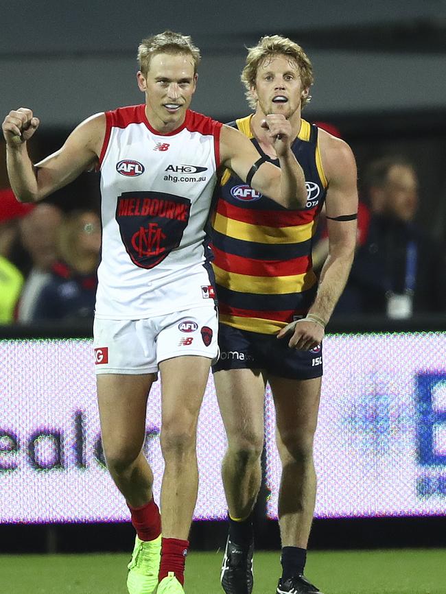 Bernie Vince celebrates a goal for Melbourne in front of former teammate Rory Sloane last year. Picture Sarah Reed