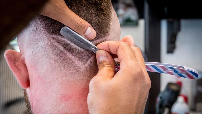 Footy fans can get a close cut for charity. Picture: Jake Nowakowski