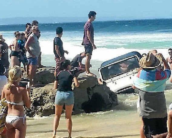 INUNDATED. A vehicle comes to grief on the Mudlo Rocks at Rainbow Beach. Picture: Contributed