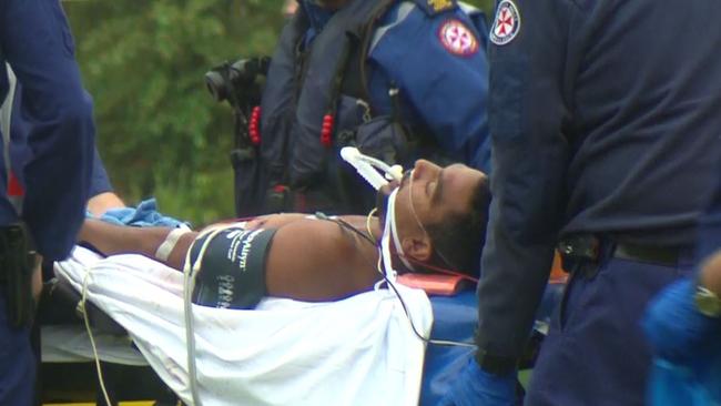 Both men were seen wailing in pain as they were wheeled into the ambulance. Picture: Top Notch Video