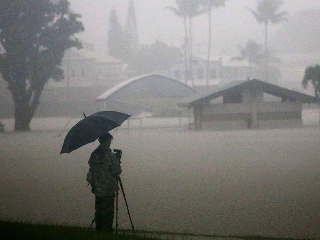 A man takes photos of floodwaters from Hurricane Lane rainfall on the Big Island in Hilo, Hawaii. Picture: Getty