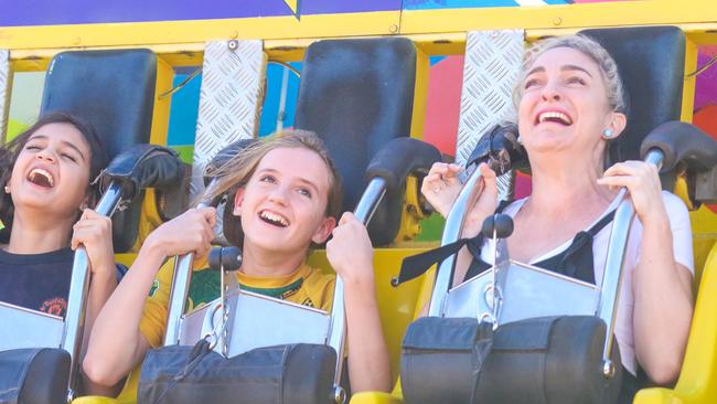 Mariya Bairamis, 14, Caitlin Sutherland, 14 and Aimee Tagell enjoying the third and final day of the Royal Darwin Show. Picture: Glenn Campbell