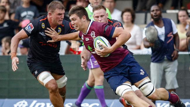 Harry Hockings pushes away from the Sharks defence.