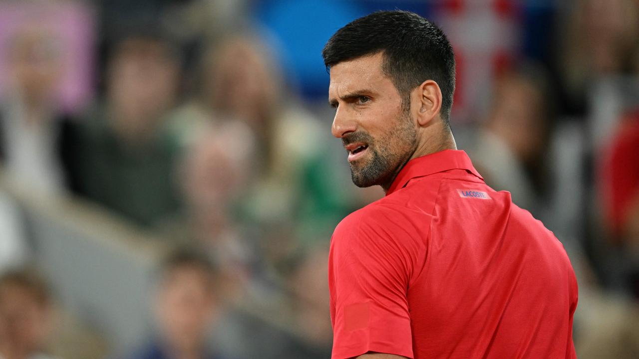 Serbia's Novak Djokovic reacts as he plays Australia's Matthew Ebden during their men's singles first round tennis match on Court Philippe-Chatrier at the Roland-Garros Stadium at the Paris 2024 Olympic Games, in Paris on July 27, 2024. (Photo by PATRICIA DE MELO MOREIRA / AFP)