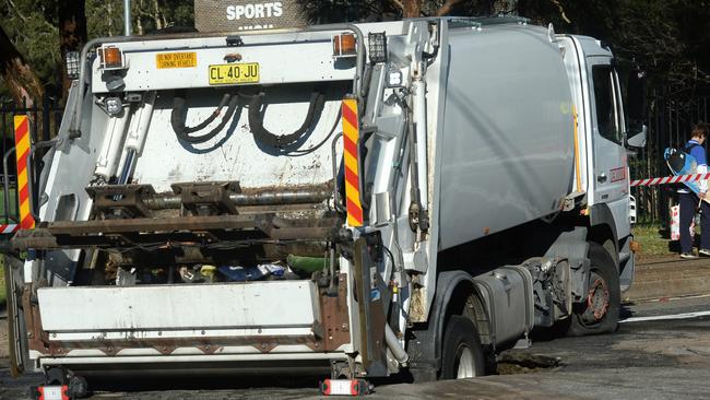SYDNEY, AUSTRALIA - NewsWire Photos JULY 29. A garbage truck falls into a busted water mains sink hole in Narrabeen ,Wednesday, July 29, 2020. Picture: NCA NewsWire / Jeremy Piper