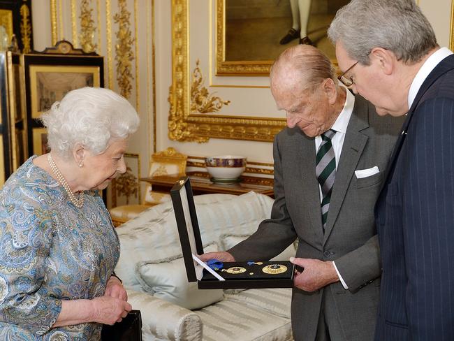 Australian High Commissioner Alexander Downer was invited to Windsor Castle to see the Queen present her husband with the Insignia of a Knight of the Order of Australia in April 2015. Prime Minister Tony Abbott’s “captain’s call” earlier that year to award the Australian knighthood was widely derided in Australia, dubbed a “knightmare” in the press and contributed to the PM’s downfall. But a new take on the story came from <i>The Australian</i>’s Greg Sheridan who wrote that Abbott was trying to do a favour for the Queen. “Abbott gave Philip a knighthood because he learned the Queen wanted her husband to have one,” he said. “The Queen’s son, Prince Charles, had a number of Australian honours but Philip had not been so richly rewarded by Australia.” Picture: AFP