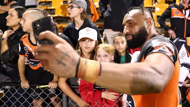 Justin Olam of the Tigers celebrates with fans at Leichhardt Oval. Picture: Getty Images