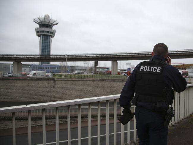 A police officer patrols at the Orly Airport, with its control tower in background, south of Paris. Picture: AP