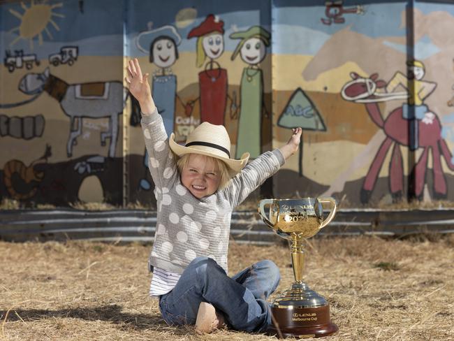 Elsie Leslie, 3, at the racetrack at Brunette Downs, near Tennant Creek in the NT. The water tank behind Ellie was painted by Dolly Everett (whose loving family started suicide prevention charity Dolly’s Dream in her honour) and her sister, Meg. Picture: Alex Coppel