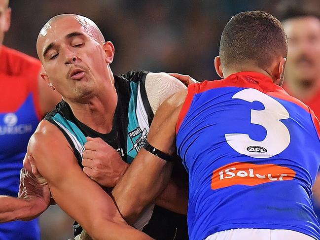 ADELAIDE, AUSTRALIA - JUNE 22: Sam Powell-Pepper of the Power is tackled by Christian Salem of the Demons during the round 14 AFL match between the Port Adelaide Power and the Melbourne Demons at Adelaide Oval on June 22, 2018 in Adelaide, Australia.  (Photo by Daniel Kalisz/Getty Images)