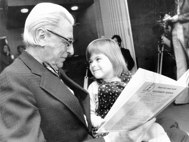 American author Dr. Seuss (Theodor Seuss Geisel), 73, reading with young SA girl Kimberley Campbell, 3, in Adelaide in 1976.