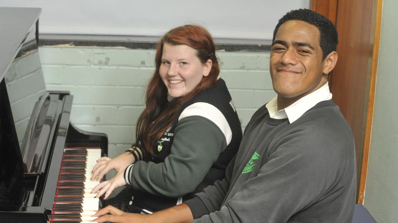 Jordan Mailata signs alongside classmate Rachel Small.