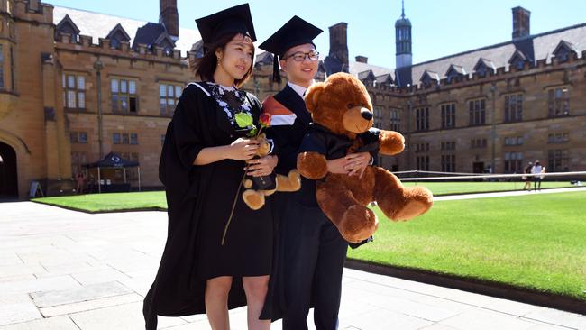 Students from China pose for family photos after graduating from Sydney University. Picture: AFP