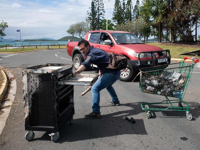 A local resident clear the roads of burnt detritus left by rioters at the N'Gea traffic circle in Noumea. Picture: AFP