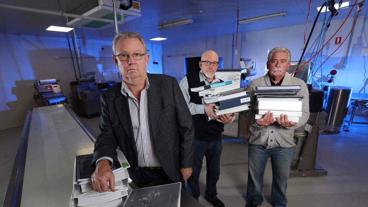 The Boss of iCook, Ian Cook with retired Detective Sergeant Paul Brady and retired Detective Inspector Rod Porter, with the mountain of evidence submitted to Victoria Police.. Picture: Alex Coppel.