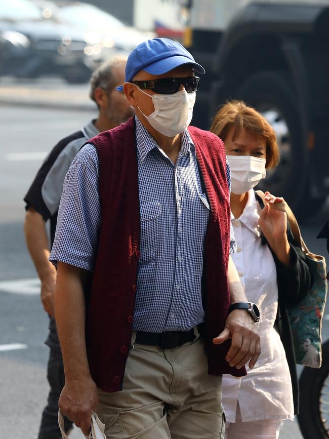 As smoke from bushfires engulfs Sydney, morning commuters are pictured wearing face masks as they make their way to work. Picture: MATRIX