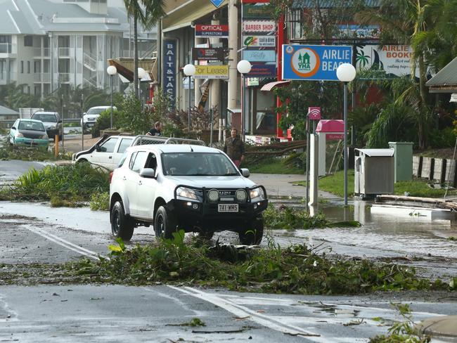 The streets of Airlie Beach are littered with fallen tree branches. Picture: Liam Kidston