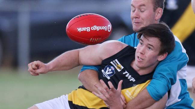 Jordon Buckley vies for position in a marking contest for Woorndoo Mortlake. Picture: Yuri Kouzmin.