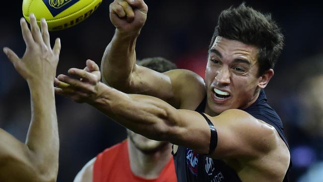 Carrazzo shoots out a handball during his AFL career. Picture: AAP/Julian Smith