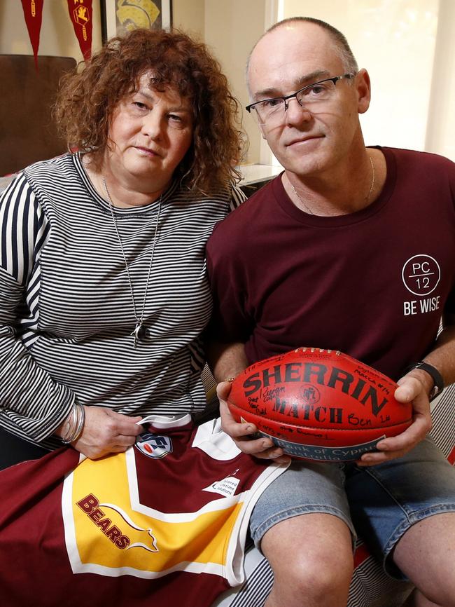 Robyn and Matt Cronin sit in Patrick's bedroom with his Lower Plenty footy jumper and U16 Grand Final football. Picture: David Caird