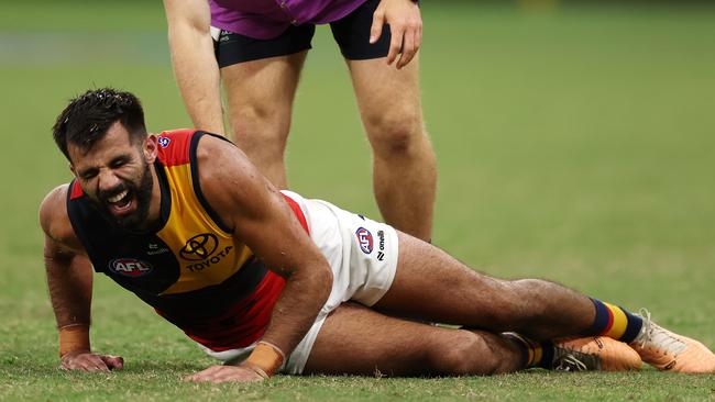 PERTH, AUSTRALIA - MARCH 29: Wayne Milera of the Crows is assessed after injuring his leg during the 2024 AFL Round 03 match between the Fremantle Dockers and the Adelaide Crows at Optus Stadium on March 29, 2024 in Perth, Australia. (Photo by Will Russell/AFL Photos via Getty Images)