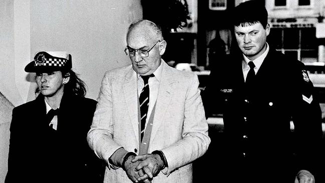 A handcuffed Risdale is led into Melbourne County Court to face charges of sexual abuse of altar boys and other young victims in 1994.