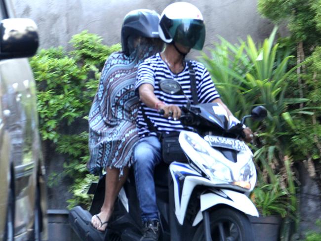 A woman believed to be Schapelle Corby arrives on the back of a motorbike taxi at her house in Kuta, Bali, on May 17. Picture: Lukman S. Bintoro