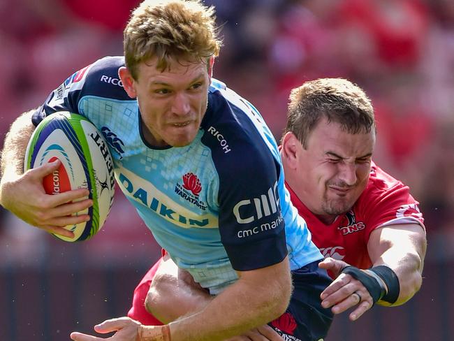 Bryce Hegarty of the Waratahs is tackled by Ruan Dreyer of the Emirates Lions during the SuperRugby match between Emirates Lions and Waratahs at the Emirates Airline Park-Johannesburg, on March 4, 2017 in Johannesburg. / AFP PHOTO / CHRISTIAAN KOTZE