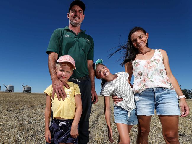 28/1/2021Russell Burges and Rebekah with their children Tayla (8, blue cap)and Rylie (6, pink cap) on their barley farm at Meckering Pic Colin Murty The Australian