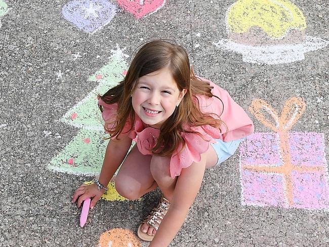 Billy Dumanovic 7 and Stasia Vuckovic  helping SALA artist Bella Whittaker draw on her driveway to celebrate the Christmas Pageant experience at home Thursday November 5,2020.Picture Mark Brake