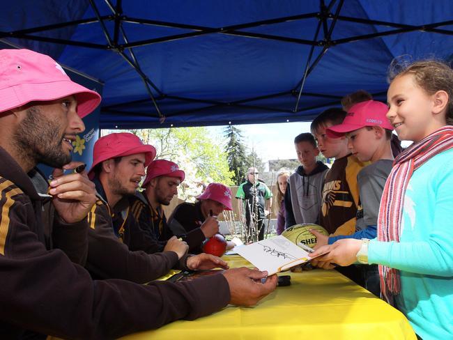 Hawthorn premiership player Josh Gibson gives his autograph to Isabel Brown, 10, of Launceston. Picture: ROSS MARSDEN