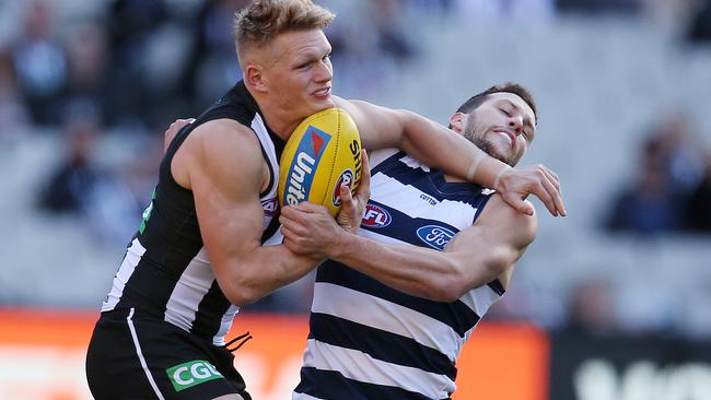 Adam Treloar tries to fend off Sam Menegola. Picture: Michael Klein