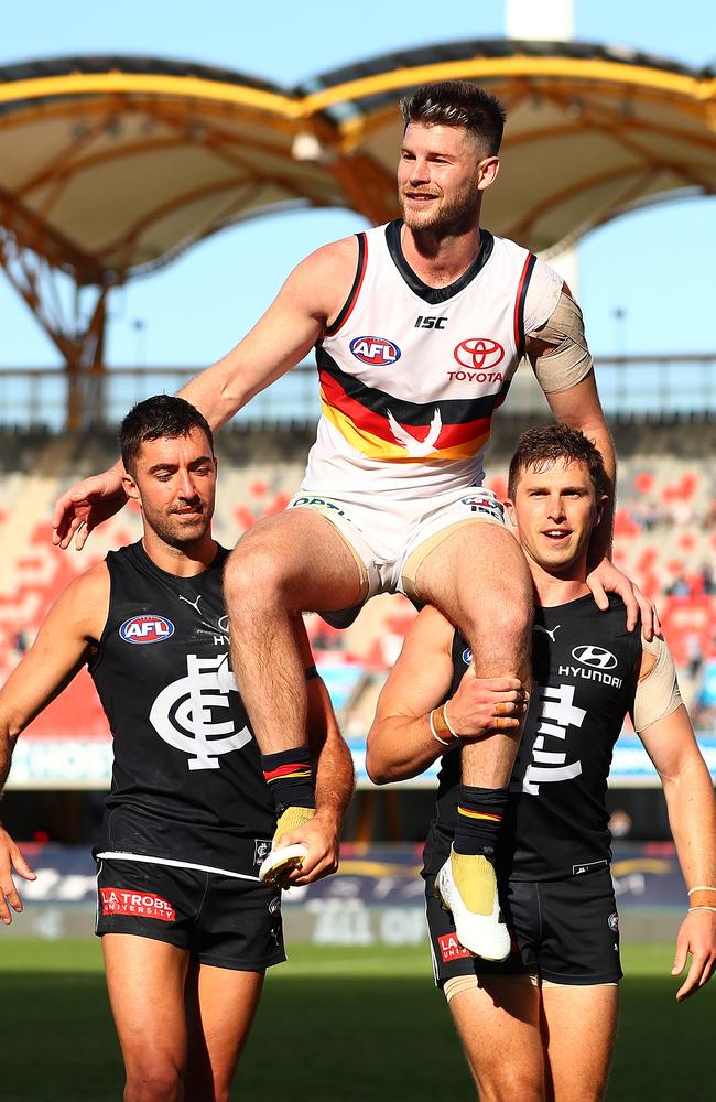 Bryce Gibbs gets chaired off by his old Carlton teammates after his final game. Picture: Chris Hyde/Getty Images