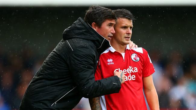 Harry Kewell gives Crawley Town star Dean Cox instructions.