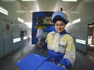 MOTORING ON: Apprentice bus painter Dimitria Klokas enjoys the challenge of difficult repairs. Picture: Dominic O'Brien