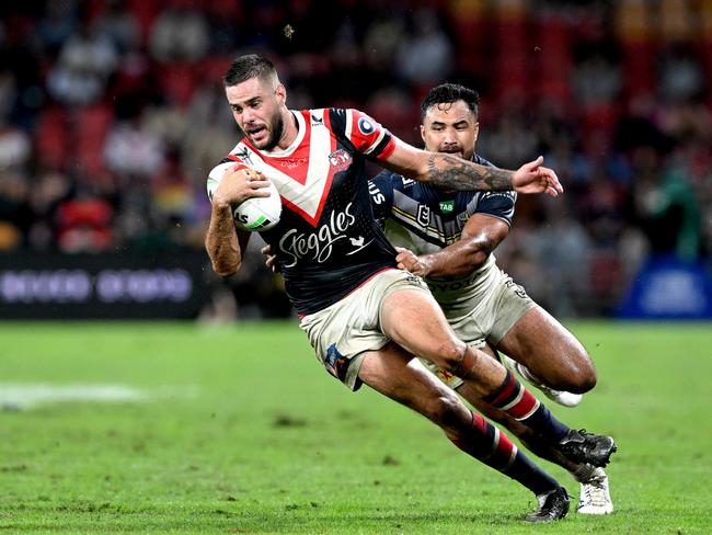 Corey Allan of the Roosters attempts to break free from Peta Hiku. Picture: Getty Images