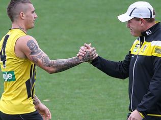 AFL. Richmond training at Punt Road oval in preparation for the season opening game against Carlton. Assistant coach JustinLeppitsch and Dustin Martin greet each other on the track. Picture : Ian Currie