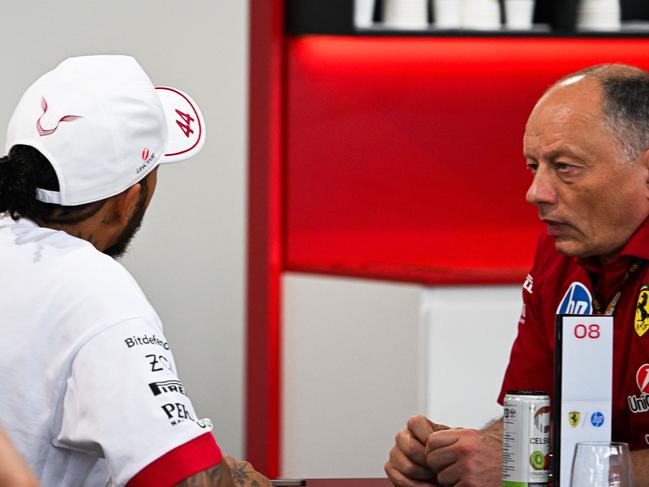 (L-R) Ferrari's British driver Lewis Hamilton Ferrari's and French team principal Frederic Vasseur speak with each other before the start of the 2025 Miami Formula One Grand Prix at Miami International Autodrome in Miami Gardens, Florida, on May 4, 2025. (Photo by CHANDAN KHANNA / AFP)