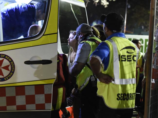 Paramedics treat a young woman in the van following a suspected overdose at the Field Day music festival, before rushing her to hospital. Picture: Gordon McComiskie