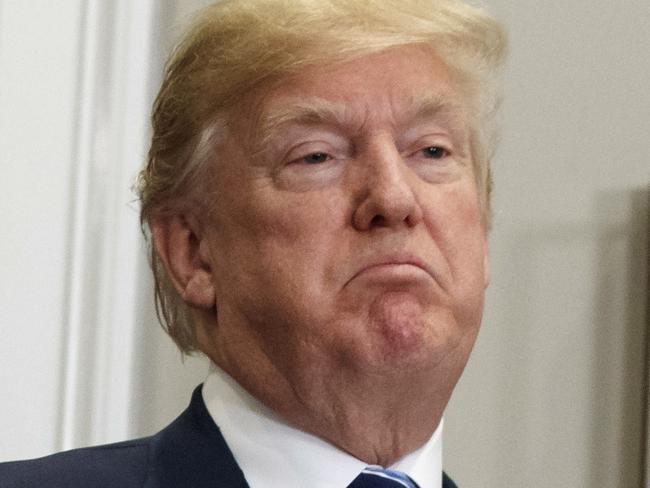 President Donald Trump pauses as he speaks to reporters during an event on federal regulations in the Roosevelt Room of the White House, Thursday, Dec. 14, 2017, in Washington. (AP Photo/Evan Vucci)