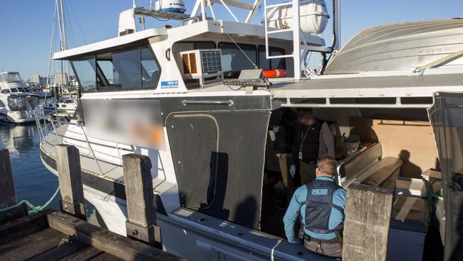 Investigators board a boat during the raid. Picture: Supplied