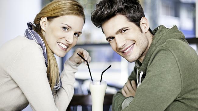 A couple on a dry date drinking milkshakes.