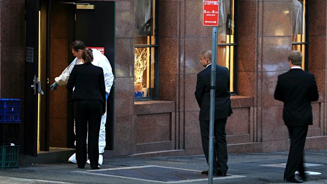 Investigators examine the crime scene at the Lindt Cafe in Martin Place, Sydney where two hostages lost their lives in the December 2014 siege. Picture: Craig Greenhill