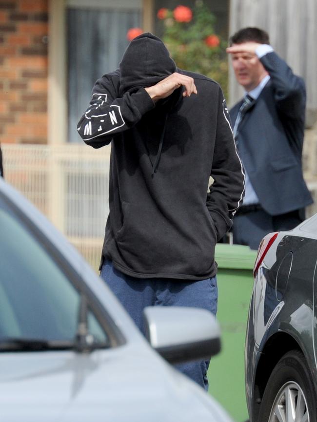 A man talks to police in Meadow Heights. Picture: Andrew Henshaw