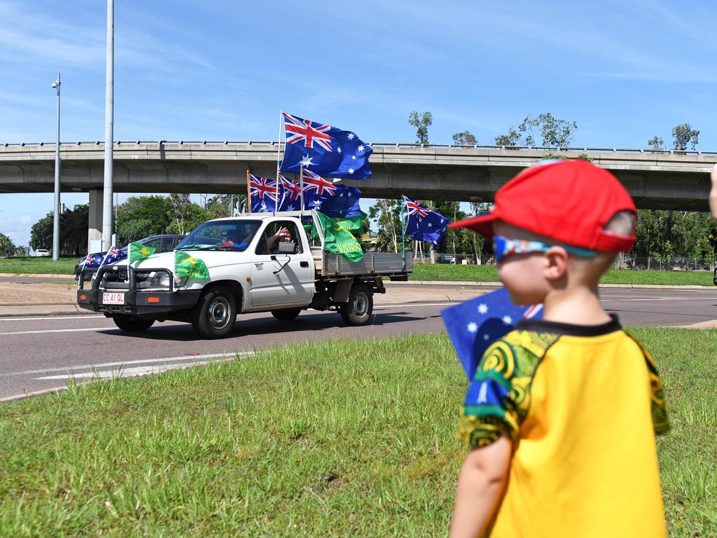 Kiam Hardman, 2, watches on as a ute rounds the corner at the Ludmilla flyover as part of the annual Variety NT Australia Day Ute run. Picture: Che Chorley