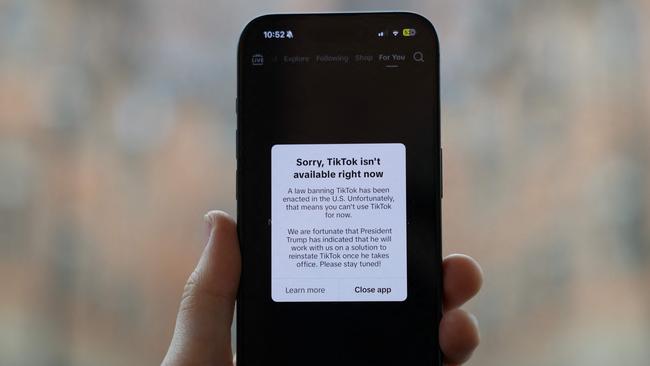 WASHINGTON D.C. - JANUARY 19: In this photo illustration an iPhone displays a popup message on the social media platform TikTok on January 19, 2025 in Washington, D.C. On January 18th the popular platform was no longer available to users inside of the United States after a U.S. Supreme Court ban took effect. (Photo illustration by Kayla Bartkowski/Getty Images) (Photo by Kayla Bartkowski / GETTY IMAGES NORTH AMERICA / Getty Images via AFP)